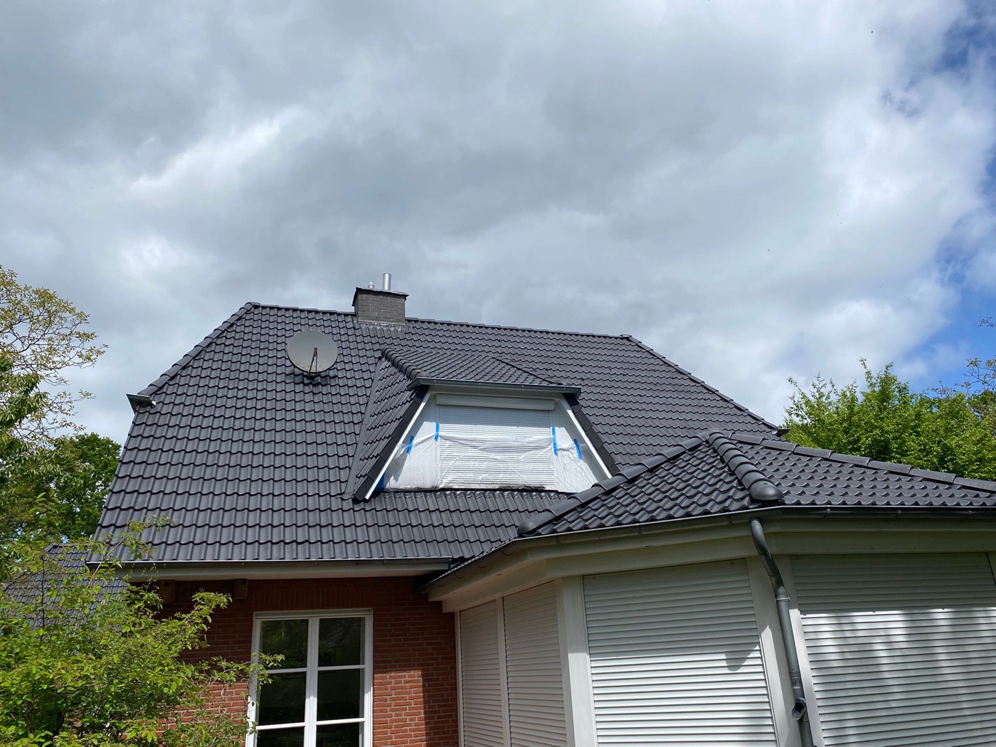 Backsteinhaus mit anthrazitfarben beschichtetem Dach